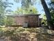 Backyard featuring brick home with mature trees and a partially shaded area at 6576 Randall Mark Dr, Morrow, GA 30260