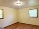 Bedroom with neutral paint, wood floors, and windows for natural light at 6576 Randall Mark Dr, Morrow, GA 30260