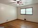 Bedroom featuring neutral paint, wood floors, ceiling fan, and windows for natural light at 6576 Randall Mark Dr, Morrow, GA 30260