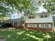 Two-story home with brick and siding, featuring a covered side entrance and a well-maintained lawn at 6576 Randall Mark Dr, Morrow, GA 30260