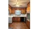Kitchen featuring knotty pine cabinets, white countertops, and black appliances at 6576 Randall Mark Dr, Morrow, GA 30260