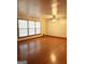 Large, bright living room featuring hardwood floors, a ceiling fan, and large windows at 6576 Randall Mark Dr, Morrow, GA 30260