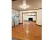Open-concept space with hardwood floors, an open doorway, a white stone fireplace and a chandelier at 6576 Randall Mark Dr, Morrow, GA 30260