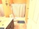 Bathroom featuring a white toilet, vanity sink, and shower/tub combo with curtain at 3311 Thornbridge Dr, Powder Springs, GA 30127