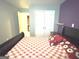This bedroom features a large double bed and a mix of pastel and purple walls at 3311 Thornbridge Dr, Powder Springs, GA 30127