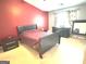 This bedroom features red accent wall, side tables, and bed with dark bedding at 3311 Thornbridge Dr, Powder Springs, GA 30127
