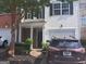 Charming two-story townhome with stone accents, attached garage, and well-maintained landscaping at 3311 Thornbridge Dr, Powder Springs, GA 30127