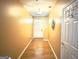 Well-lit hallway with hardwood floors leading to the front door and other areas of the home at 3311 Thornbridge Dr, Powder Springs, GA 30127