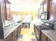 Well-equipped kitchen with dark cabinetry, modern appliances, and an open view to the dining area at 3311 Thornbridge Dr, Powder Springs, GA 30127