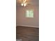 Bedroom with hardwood floors and a window with outside views, creating a cozy space at 6286 Saddlewood Dr, Lithonia, GA 30058