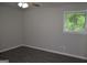 This bedroom offers natural light with a ceiling fan and new, modern flooring at 6286 Saddlewood Dr, Lithonia, GA 30058