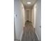 Hallway boasts hardwood flooring and neutral paint, leading to rooms and storage at 6286 Saddlewood Dr, Lithonia, GA 30058