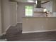 Open-concept kitchen boasts sleek white cabinets, stone countertops and modern backsplash at 6286 Saddlewood Dr, Lithonia, GA 30058
