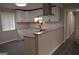 Modern kitchen with granite countertops, white subway tile backsplash, stainless steel vent hood, and gray plank flooring at 6286 Saddlewood Dr, Lithonia, GA 30058