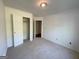 Bright bedroom featuring a neutral carpet, white walls, and closet at 127 Jenny Rd, Grantville, GA 30220