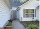Inviting front entrance with decorative window shutters, a well-maintained walkway, and lush landscaping at 127 Jenny Rd, Grantville, GA 30220