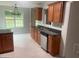 Functional kitchen featuring stainless steel appliances, dark countertops, and wood cabinets at 127 Jenny Rd, Grantville, GA 30220