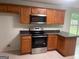 Modern kitchen with stainless steel appliances, ample cabinet space, and dark countertops at 127 Jenny Rd, Grantville, GA 30220