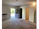 A spacious living room features neutral carpeting and a decorative wreath on the front door at 127 Jenny Rd, Grantville, GA 30220