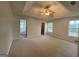 Spacious main bedroom with a tray ceiling, fan, and carpet at 127 Jenny Rd, Grantville, GA 30220