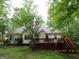 View of the home's rear, with a spacious wooden deck perfect for outdoor entertaining at 25 Lake Charles Ct, Covington, GA 30016