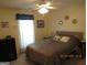 Serene bedroom featuring a ceiling fan and neutral colors, ideal for rest and relaxation at 25 Lake Charles Ct, Covington, GA 30016