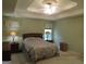 Comfortable bedroom with a tray ceiling, providing a cozy retreat for relaxation at 25 Lake Charles Ct, Covington, GA 30016