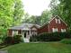 Charming single-Gathering home featuring brick facade, dormer window, and landscaped front yard at 25 Lake Charles Ct, Covington, GA 30016
