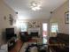 Spacious living room features hardwood floors, a fireplace, and natural light from the windows at 25 Lake Charles Ct, Covington, GA 30016