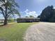 Backyard view, showing the house and gravel driveway at 72 S Bethany Rd, Mcdonough, GA 30252