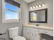 Bright bathroom features a granite vanity, framed mirror, and natural light from the window at 72 S Bethany Rd, Mcdonough, GA 30252