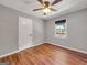 Serene bedroom with neutral walls, wood-look floors, and a large sunny window at 72 S Bethany Rd, Mcdonough, GA 30252
