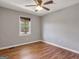 Cozy bedroom features a ceiling fan, wood-look flooring, and a window view at 72 S Bethany Rd, Mcdonough, GA 30252
