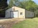 Large, versatile garage with a roll-up door, pedestrian access and vintage Coca-Cola signage at 72 S Bethany Rd, Mcdonough, GA 30252