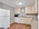 Well-lit kitchen with white appliances, granite countertops, and cream-colored cabinets at 72 S Bethany Rd, Mcdonough, GA 30252