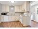 Charming kitchen with white appliances and cabinets, paired with modern granite countertops and wood-look flooring at 72 S Bethany Rd, Mcdonough, GA 30252