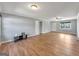 Large living room with wood-look flooring, neutral walls, and a ceiling fan for comfortable living at 72 S Bethany Rd, Mcdonough, GA 30252