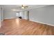 Expansive empty living room with wood-look floors, a ceiling fan, and neutral-toned walls at 72 S Bethany Rd, Mcdonough, GA 30252