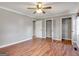 Spacious main bedroom with wood-look flooring, a ceiling fan, and two large closets at 72 S Bethany Rd, Mcdonough, GA 30252