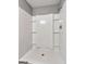 Bathroom featuring white tile shower with built-in shelves and modern shower fixtures at 72 S Bethany Rd, Mcdonough, GA 30252