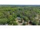 Expansive aerial view of the estate nestled within lush greenery featuring a sparkling pool at 12 Blackfoot Trl, Sharpsburg, GA 30277