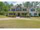 Charming two-story home with a welcoming front porch and well-manicured landscaping at 12 Blackfoot Trl, Sharpsburg, GA 30277