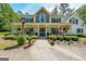 Inviting home with a wide front porch, perfect for relaxing and enjoying the serene surroundings at 12 Blackfoot Trl, Sharpsburg, GA 30277