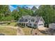 Charming two-story home with a welcoming front porch and lush landscaping at 12 Blackfoot Trl, Sharpsburg, GA 30277