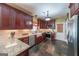 Modern kitchen featuring granite countertops, stainless steel appliances, and dark wood cabinetry at 12 Blackfoot Trl, Sharpsburg, GA 30277