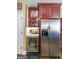Kitchen featuring stainless steel fridge, beverage cooler, wine storage, and cherrywood cabinetry at 12 Blackfoot Trl, Sharpsburg, GA 30277