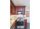 Close-up on kitchen with stainless steel stove, microwave and granite countertops with tiled backsplash at 12 Blackfoot Trl, Sharpsburg, GA 30277