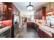 Modern kitchen with stainless steel refrigerator, cherrywood cabinets, and an adjacent bar area at 12 Blackfoot Trl, Sharpsburg, GA 30277