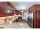Spacious kitchen boasts stainless steel appliances, granite counters and cherrywood cabinetry at 12 Blackfoot Trl, Sharpsburg, GA 30277