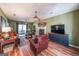 Spacious living room with a fireplace, hardwood floors, and large windows for natural light at 12 Blackfoot Trl, Sharpsburg, GA 30277